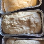 bread dough rising in pans