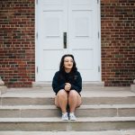 woman sitting in front of Stetson Chapel doors